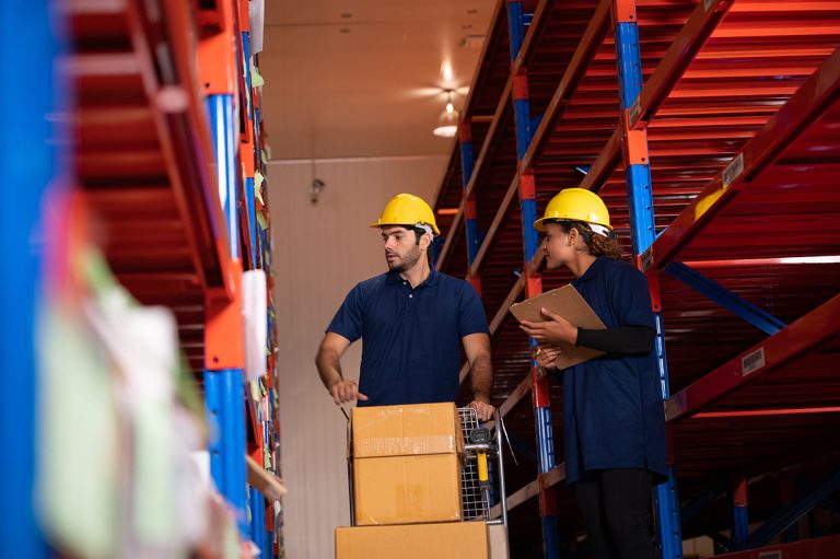 Two workers managing inventory in a warehouse