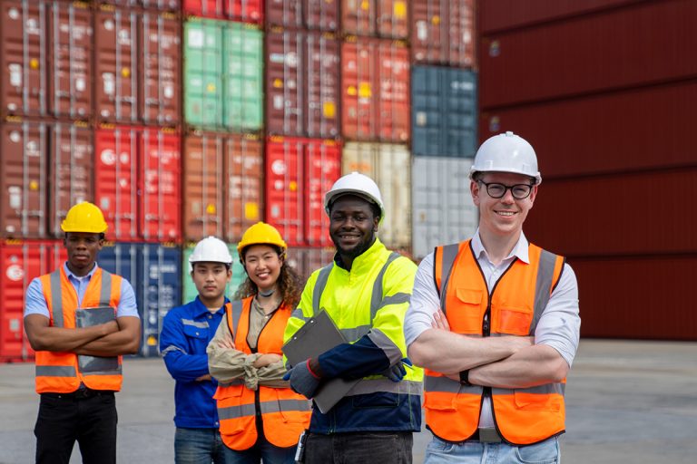 A group of logistics professionals standing in a shipping yard